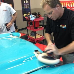 Mike Phillips buffing out a 1957 Chevy with a rotary buffer and a wool pad
