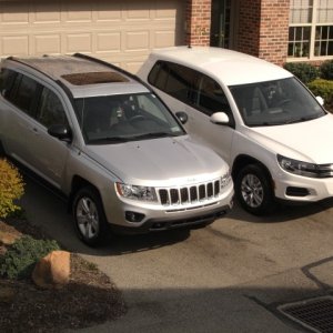 Both cars Standing tall in the driveway.