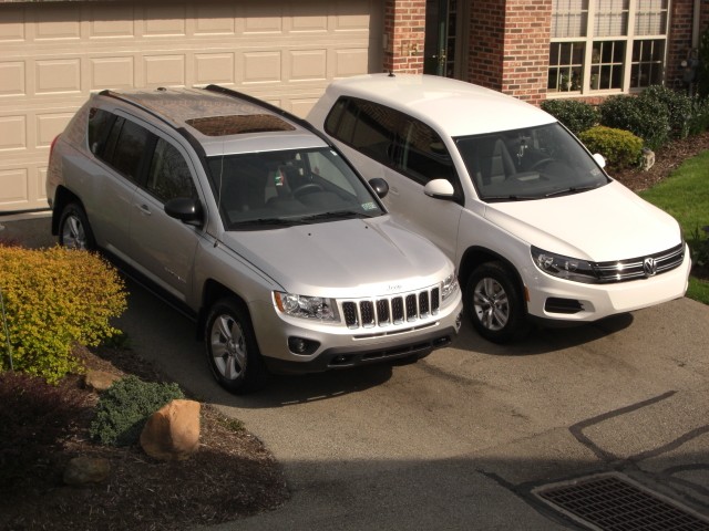 Both cars Standing tall in the driveway.