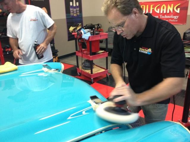Mike Phillips buffing out a 1957 Chevy with a rotary buffer and a wool pad