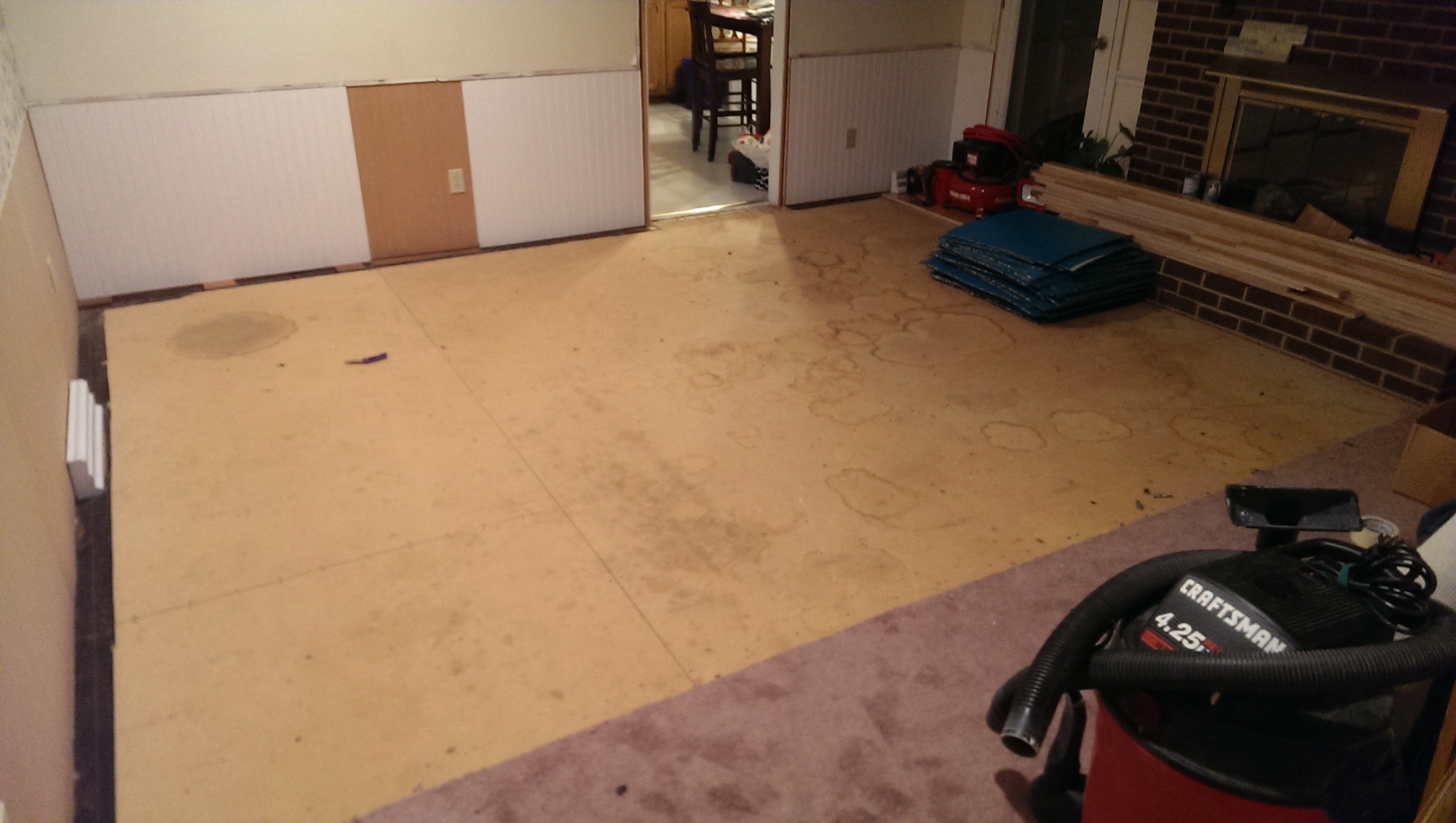 Moving on to next room, pulling out carpet and particle board